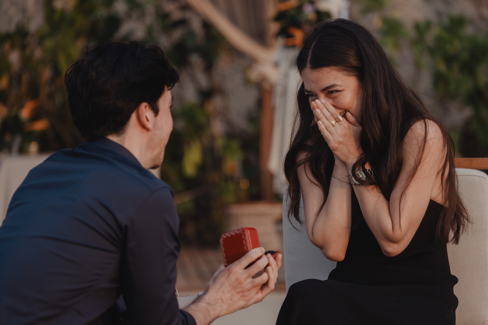 Stefano proposing to Julissa on a beach in Mexico